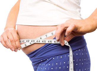 Pregnant woman measuring her bump