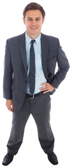 Cheerful businessman standing with hand on hip