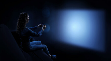 Obraz na płótnie Canvas Young woman watching movie . Mixed media