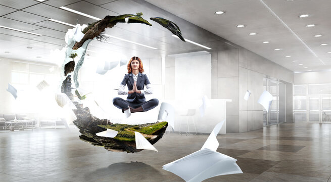 Beautiful businesswoman meditating . Mixed media