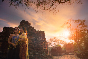 two asian woman wearing thai tradition clothes standing in old temple of ayutthaya world heritage site of unesco central of thailand