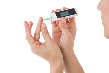 Diabetic woman using blood glucose monitor