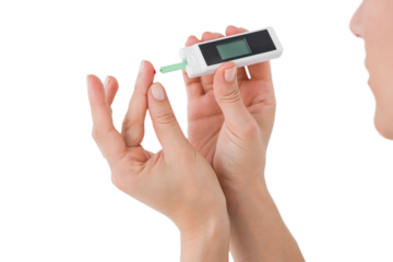 Diabetic woman using blood glucose monitor