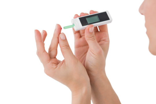 Diabetic woman using blood glucose monitor