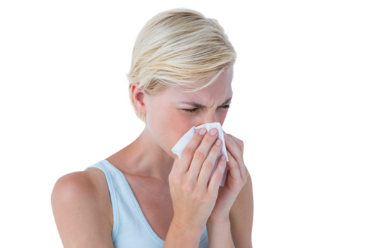 Portrait of woman blowing her nose