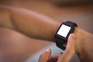 Man using smart watch in living room