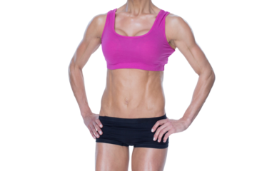 Female bodybuilder posing in pink sports bra and shorts mid section