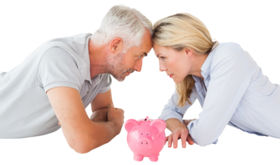 Side view of couple lying down with touching heads by piggy bank