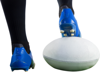 Rugby player posing feet on the ball