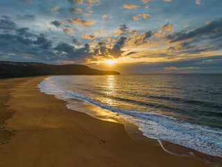 Sunrise seascape with clouds and gentle surf