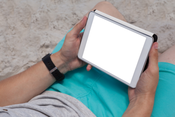 Man using digital tablet on the beach