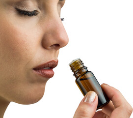 Close-up of female patient smelling medicine bottle