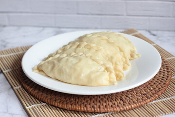 ready-to-cook raw kue pastel filled with vegetables and chicken