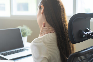 Body muscles stiff problem, ache asian young woman, girl pain neck while sitting work on chair at...