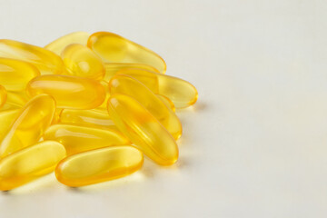 Fish oil capsules isolated on background.