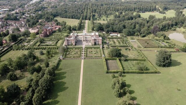 Hatfield House From South Gardens On A Sunny Day In Hatfield, Hertfordshire, England. - aerial approach