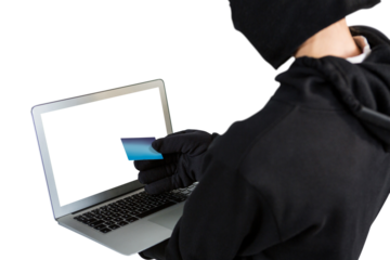 Mid section of female hacker using laptop and credit card