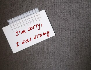 Note stick on copy space wall with text written I'M SORRY, I WAS WRONG, concept of to say sorry for...
