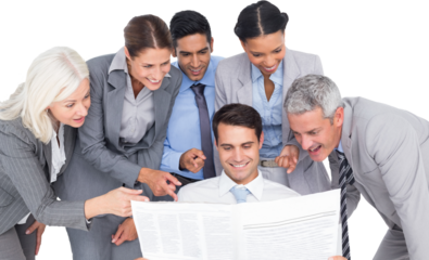 happy business people looking at newspaper 