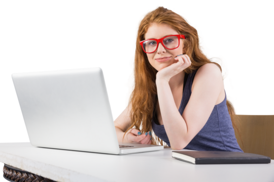 Pretty redhead working on laptop