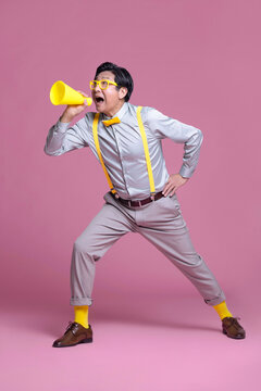 Senior Chinese man shouting through megaphone