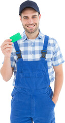 Smiling young repairman holding green card