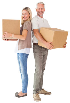 Happy couple holding moving boxes