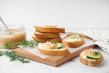 Delicious canapes with caviar of capelin on white background