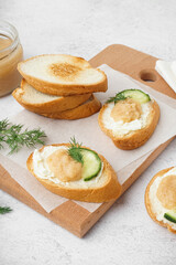 Delicious canapes with caviar of capelin on white background