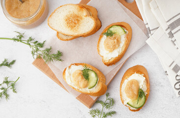 Delicious canapes with caviar of capelin on white background