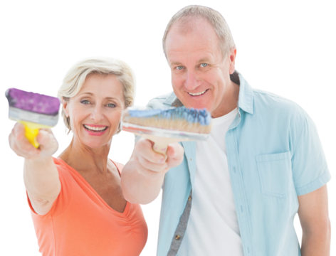 Happy older couple holding paintbrushes
