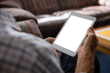 Senior man using tablet computer while sitting in nursing home