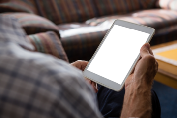 Senior man using tablet computer while sitting in nursing home