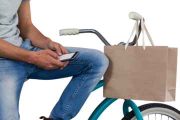 Midsection of man using phone while sitting on bicycle