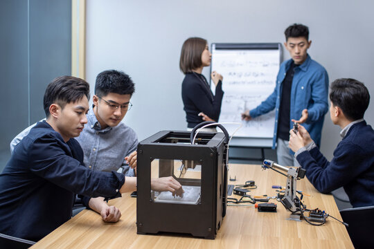 Confident Chinese designers using a 3D printer