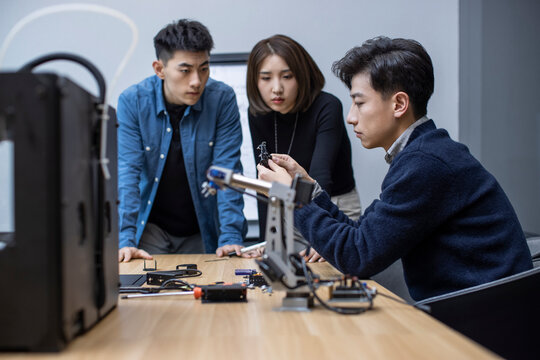Confident Chinese designers using a 3D printer