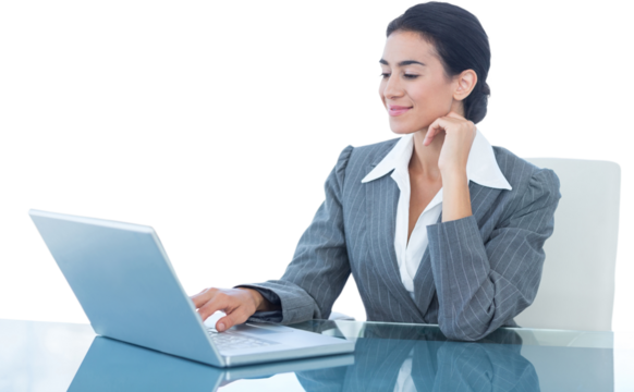 Smiling businesswoman using laptop at desk