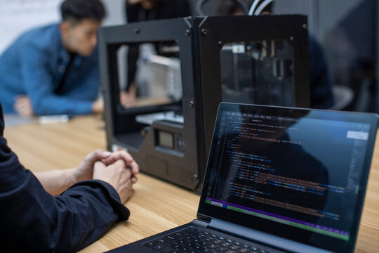 Confident Chinese designers using a 3D printer