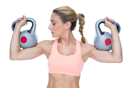Strong female crossfitter lifting kettlebells