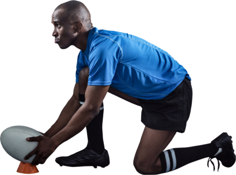 Confident rugby player looking away while keeping ball on kicking tee