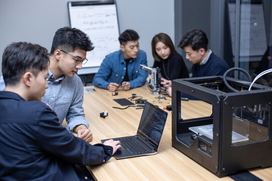 Confident Chinese designers using a 3D printer
