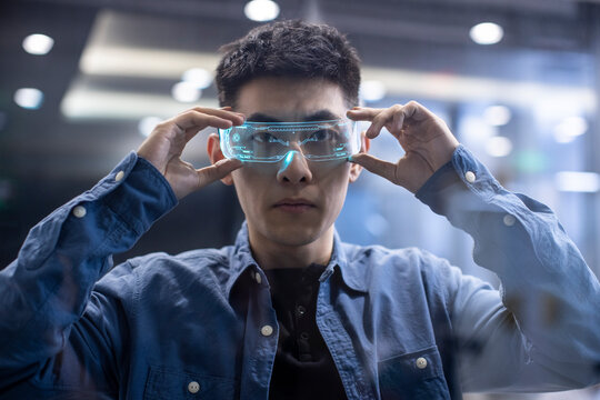 Young Chinese man wearing futuristic glasses