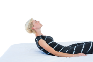 Attractive blond woman reclining on bed