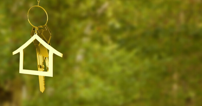 Image of house model and key hanging over defocused grassy field