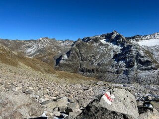 Alpine mountaineering signposts and markings in the mountainous area of the Albula Alps and above the Swiss mountain road pass Fluela (Fl&uuml;elapass), Zernez - Canton of Grisons, Switzerland (Schweiz)