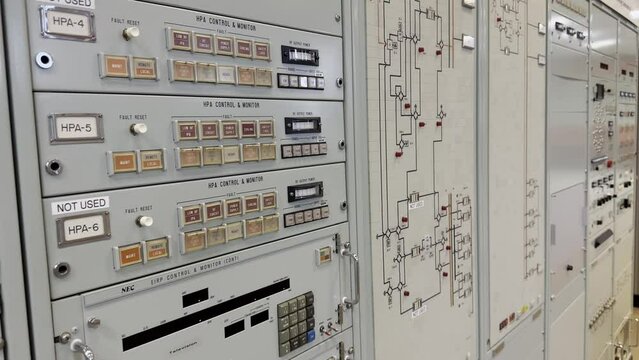 Switchgear and control point in the industry. Counter, switches and buttons on one wall. Control panel from historical times