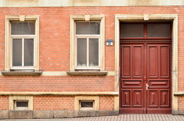 Fototapeta na wymiar View of brick building with wooden door and windows