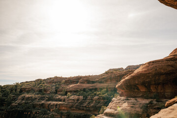 40s male hiker on ledge enjoys solitude above Boynton Canyon Sedona