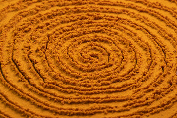 Fototapeta na wymiar Spiral poured turmeric powder spice background. Dry seasoning turmeric. Spices and herbs for cooking, curcuma