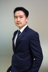 Portrait Asian business man standing look at camera  in modern office.